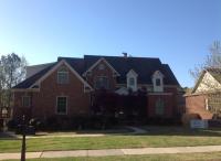 Summit Roofing, LLC team working on a large residential roof