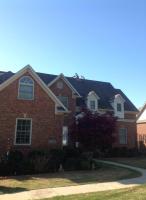 Summit Roofing, LLC team working on a large residential roof